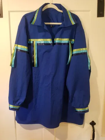 A blue jacket is hanging on a white door