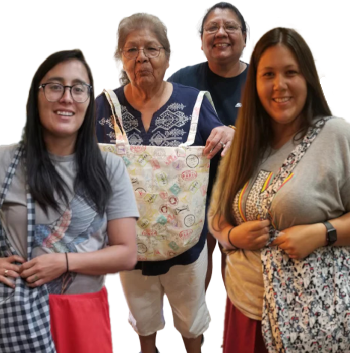 A group of women standing next to each other holding bags
