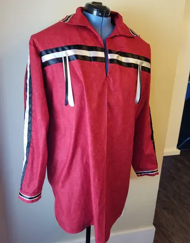 A red shirt with black and white stripes is on a mannequin