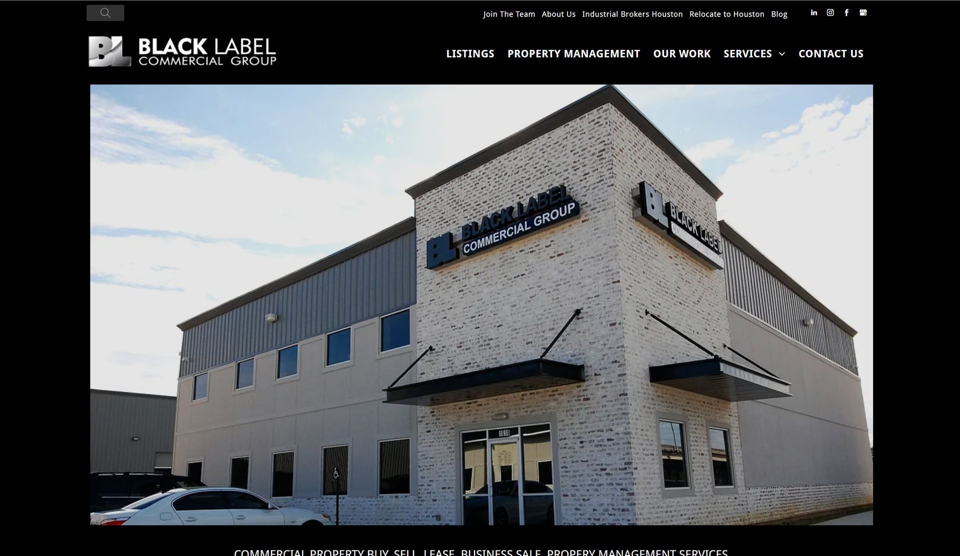 A white building with a sign that says ' black label ' on it