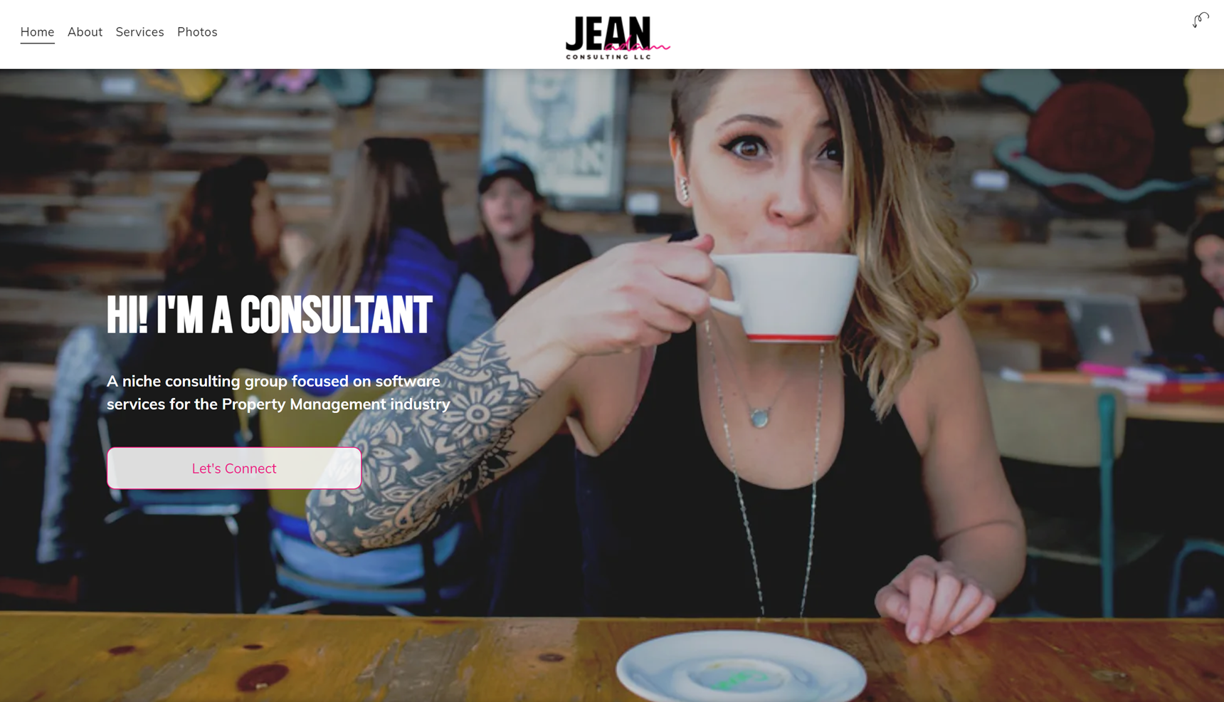 A woman is sitting at a table drinking a cup of coffee.