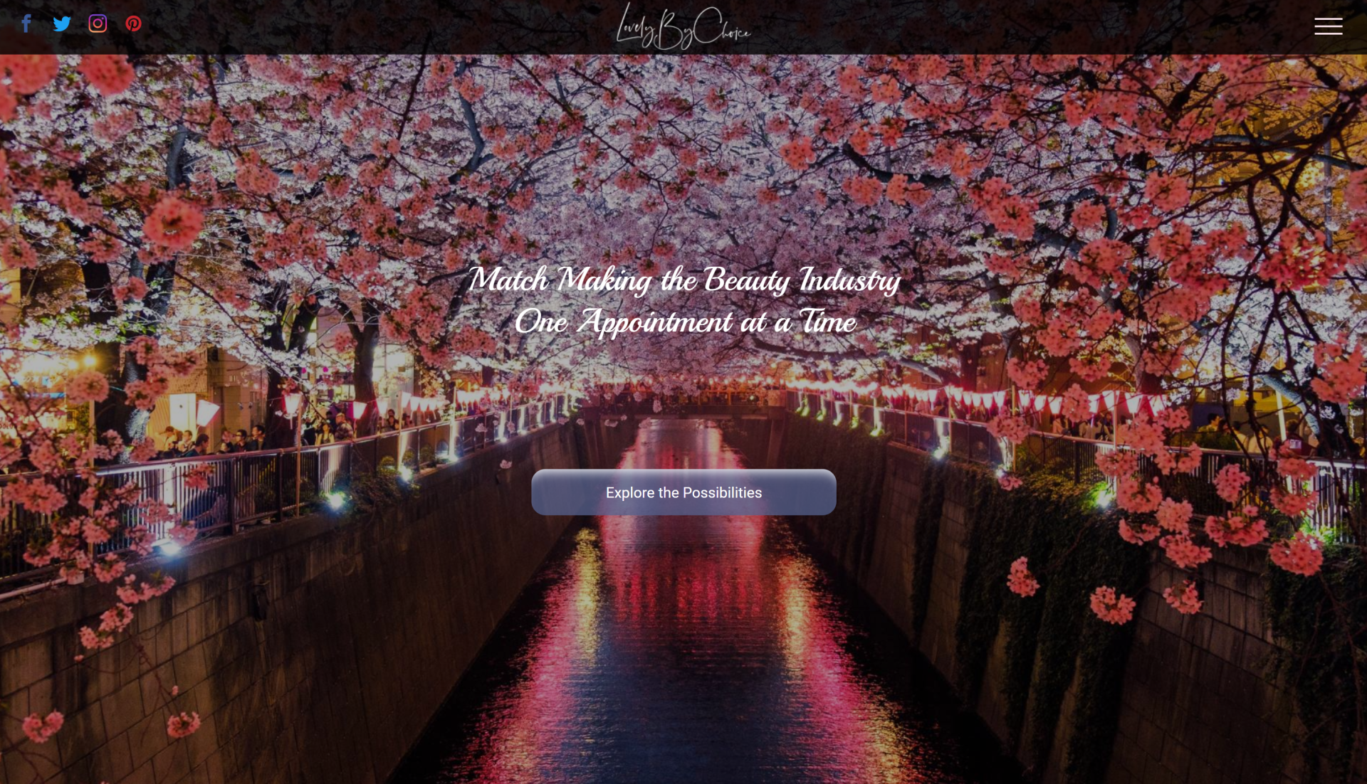 A computer screen shows a river surrounded by cherry blossom trees.