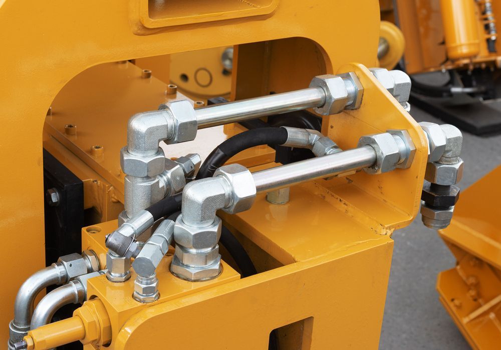 A Close Up of a Hydraulic System on a Yellow Machine — Hydrofit Service in Wollongong, NSW