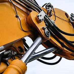 A Close Up of a Yellow Excavator With Hydraulic Hoses Attached to It — Hydrofit Service in Wollongong, NSW