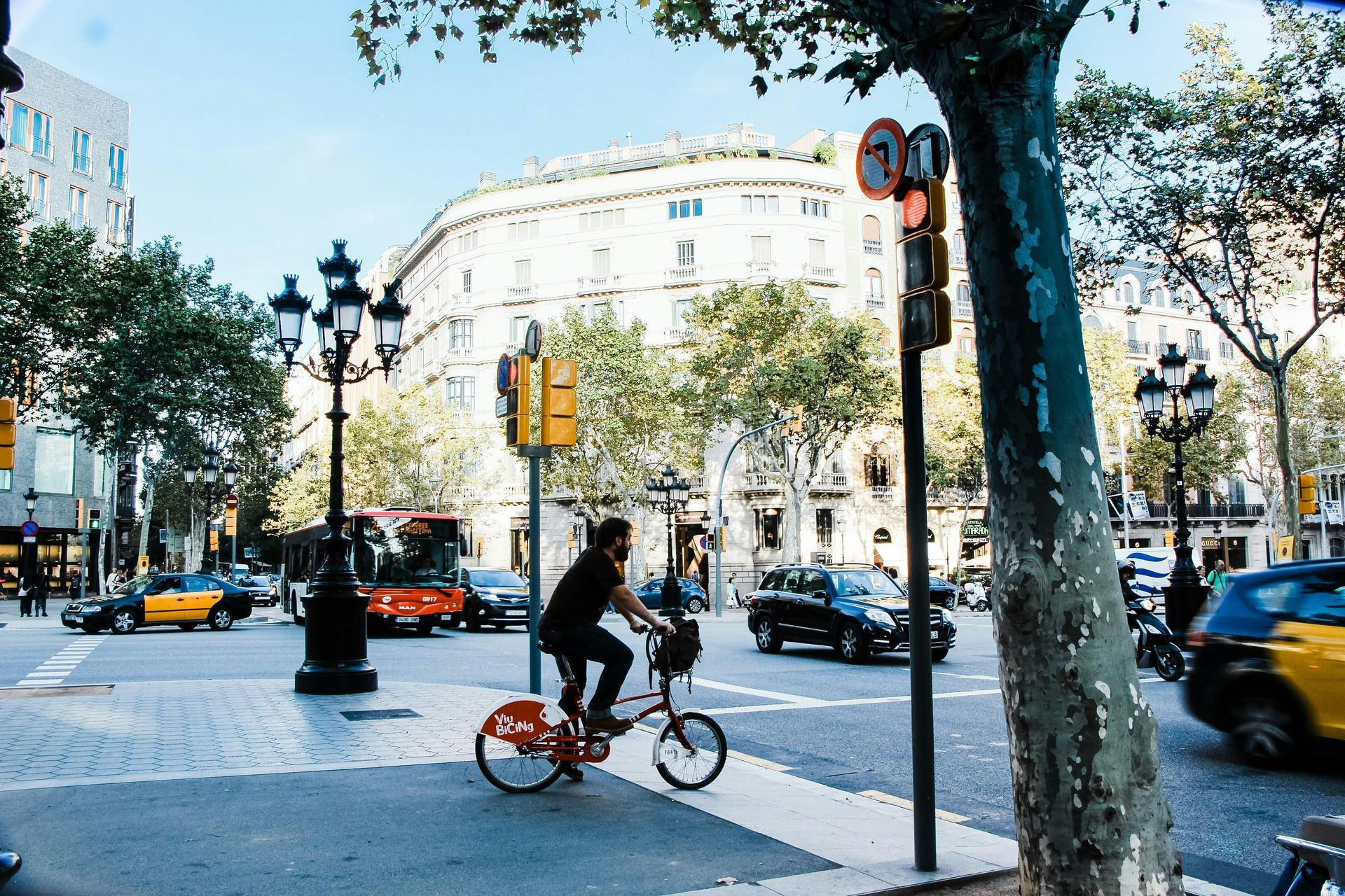 A man is riding a bike on a city street