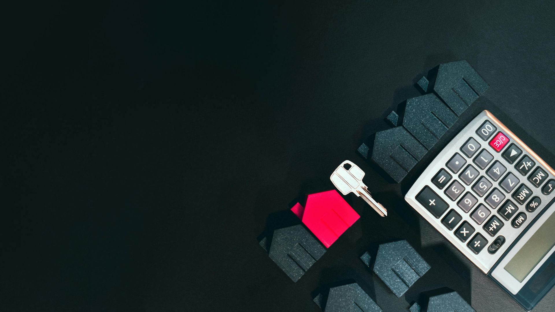 image of a key and calculator with small houses