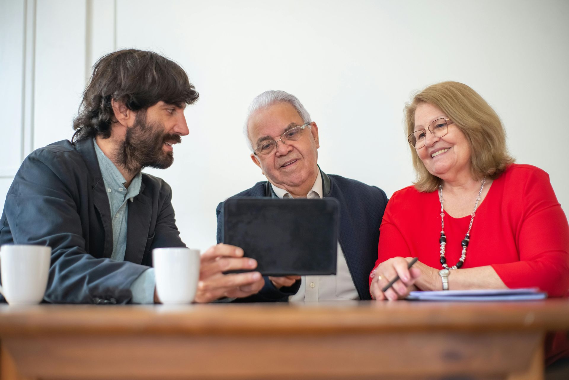 an image of a older couple sitting with a insurance agent