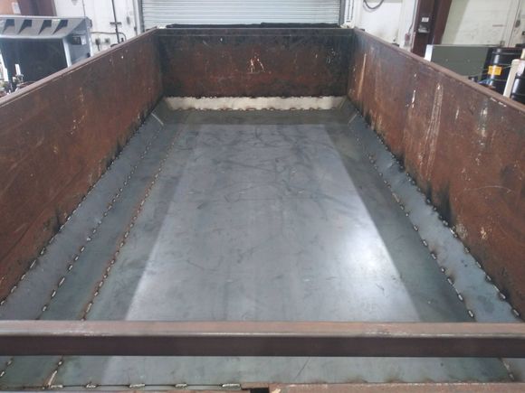 A large metal container is sitting in a garage