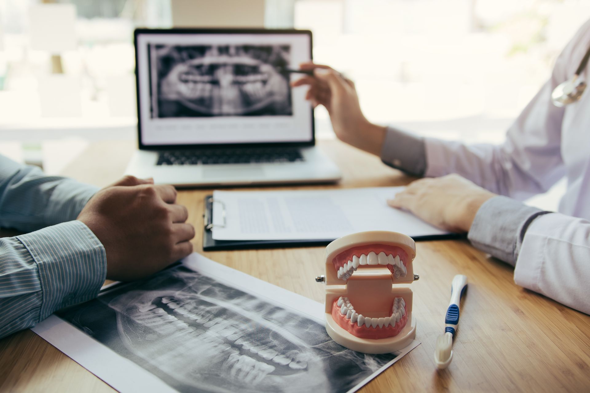 Consultation with dental X-rays, models, and patient care at a local general dental office.