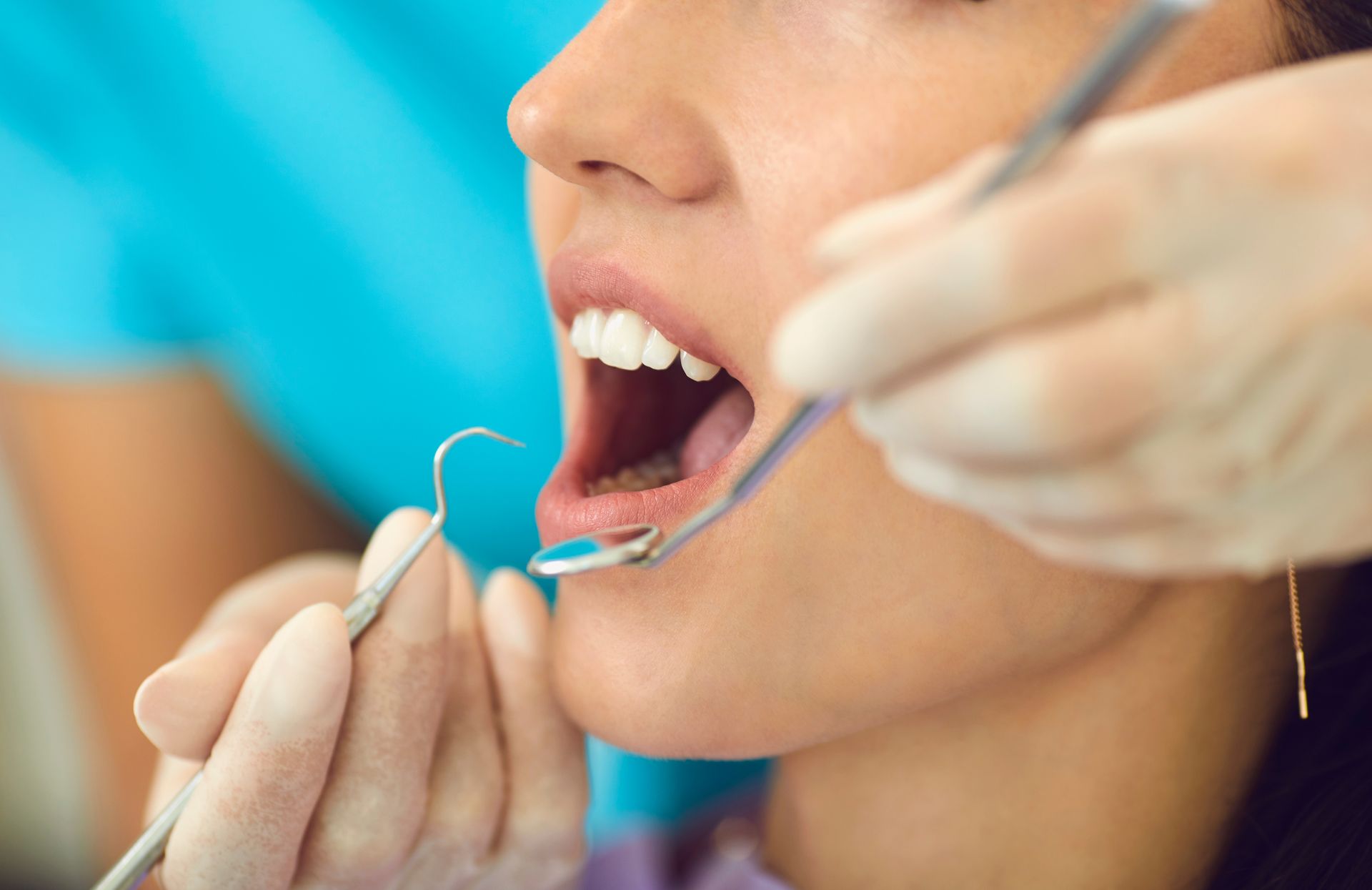 Dentist using a dental tool during an oral checkup. Dentist using a dental tool during an oral checkup.