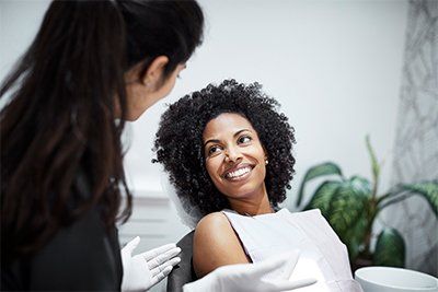Smiling Female Patient — Memphis, TN — Plaza Dental Offices The image of a person in a general dental office in Memphis, TN