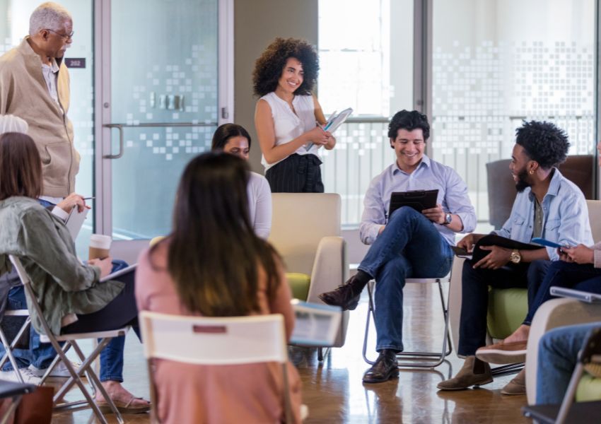 An annual HOA Board meeting is pictured, where members sit in a circle with notepads discussing the agenda with property managers.