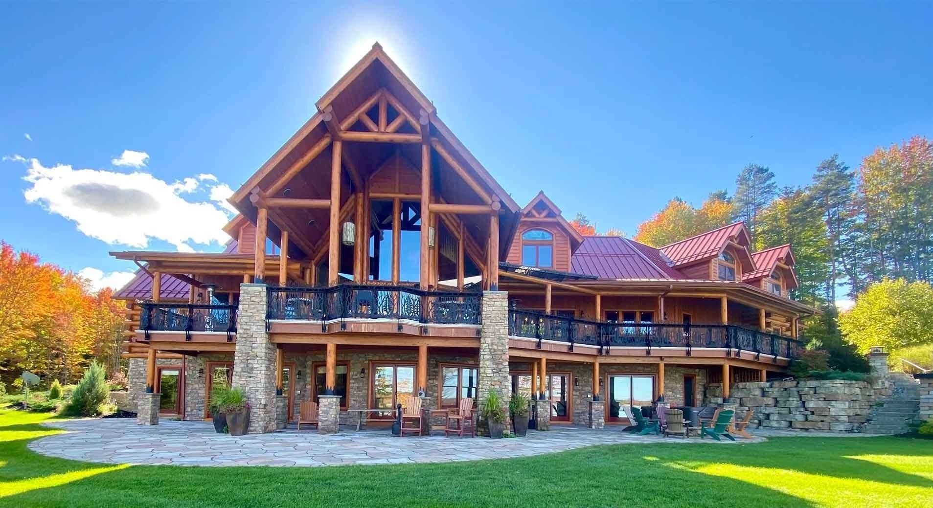 A large house with a lot of windows is surrounded by trees