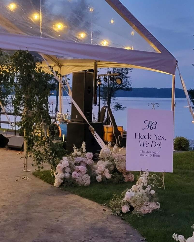 A sign under a clear tent that says i do