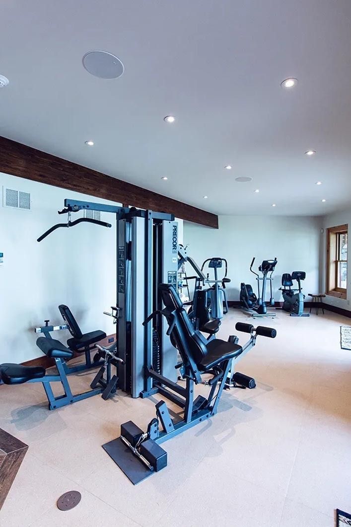 A large room filled with lots of exercise equipment.