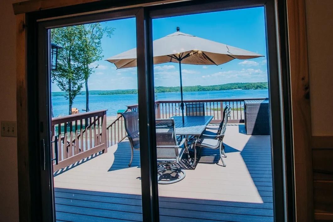 A view of a lake through a sliding glass door.