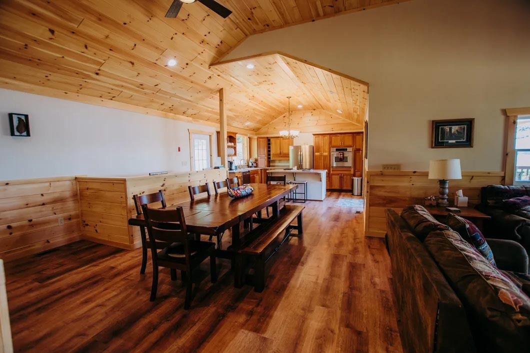 There is a table and chairs in the middle of the room.
