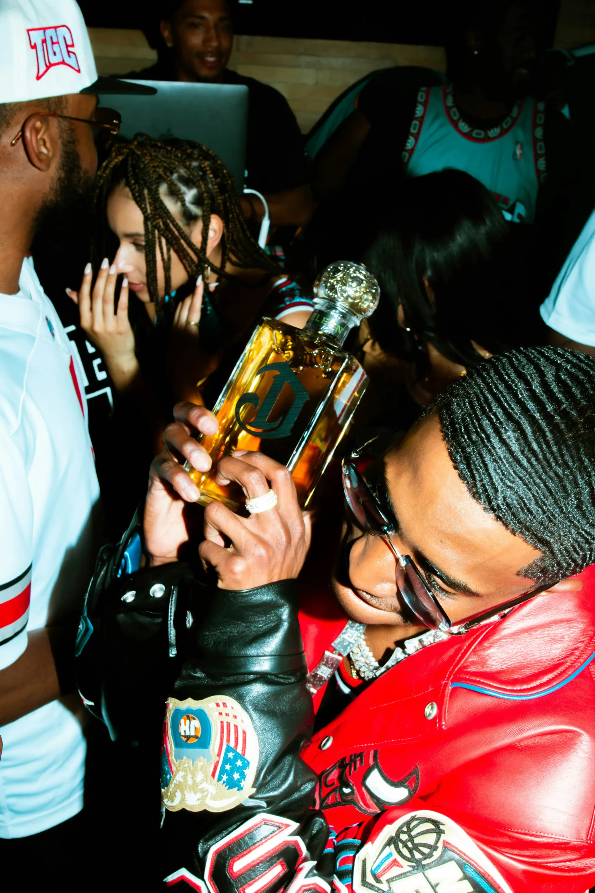 Group of people partying and holding alcohol.