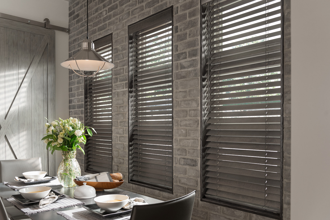 Kitchen with cabinets, sink, window with blinds, and patterned valance.
