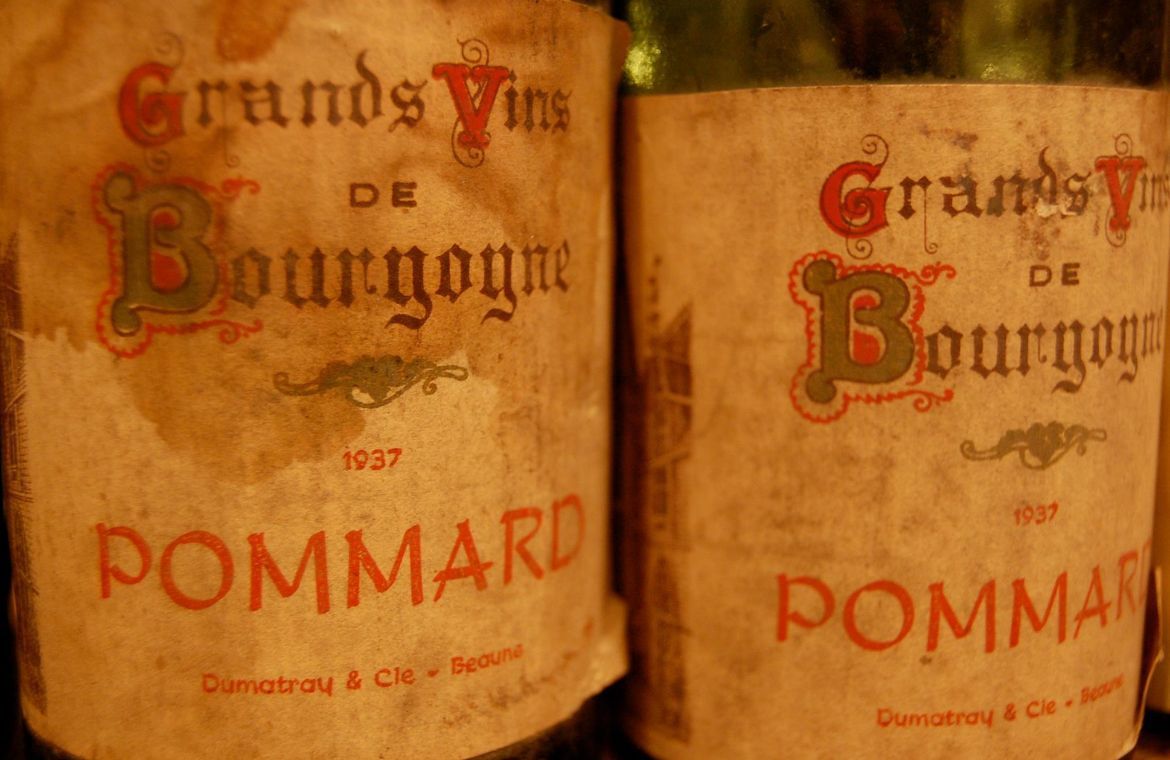 Two weathered wine bottles labeled 