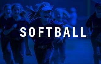 A group of girls are playing softball on a blue background.
