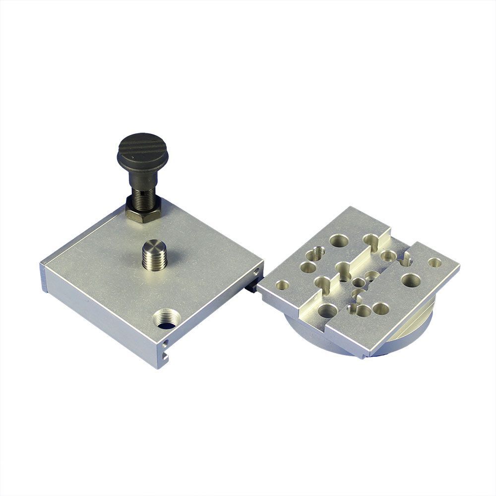 Two pieces of metal with holes in them on a white background