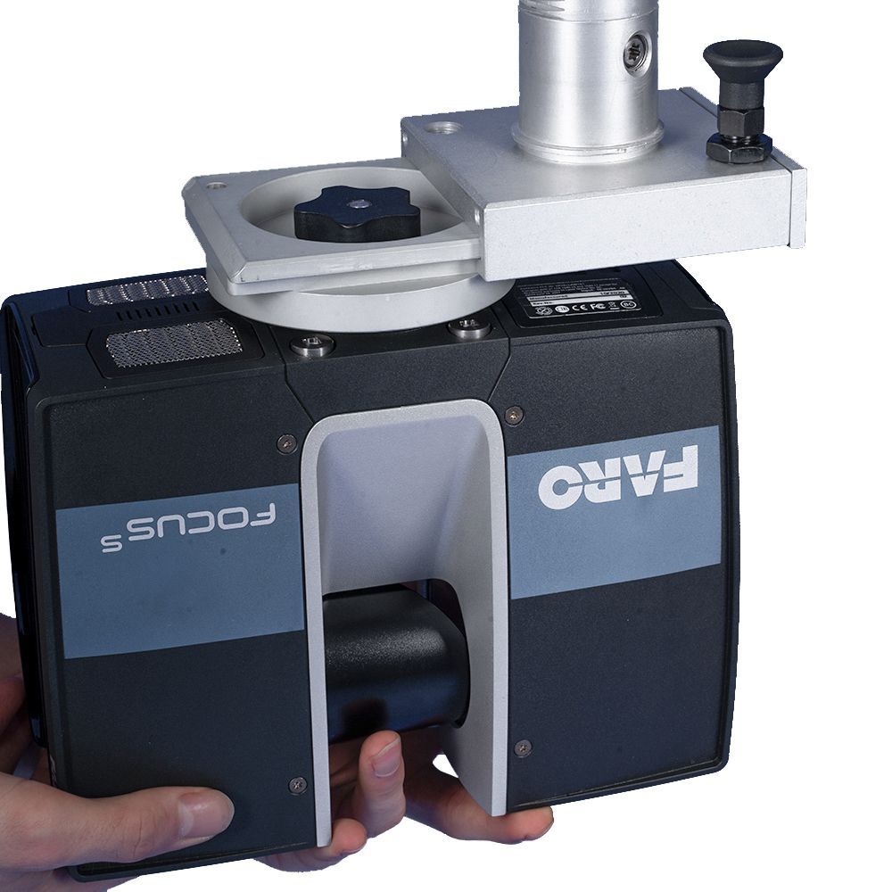 A person is holding a faro focus camera