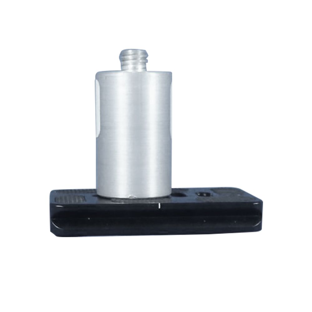 A silver cylinder is sitting on top of a black base