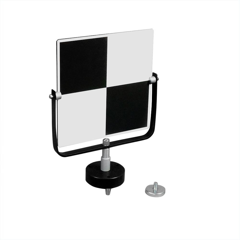 A black and white checkered sign is sitting on top of a table.