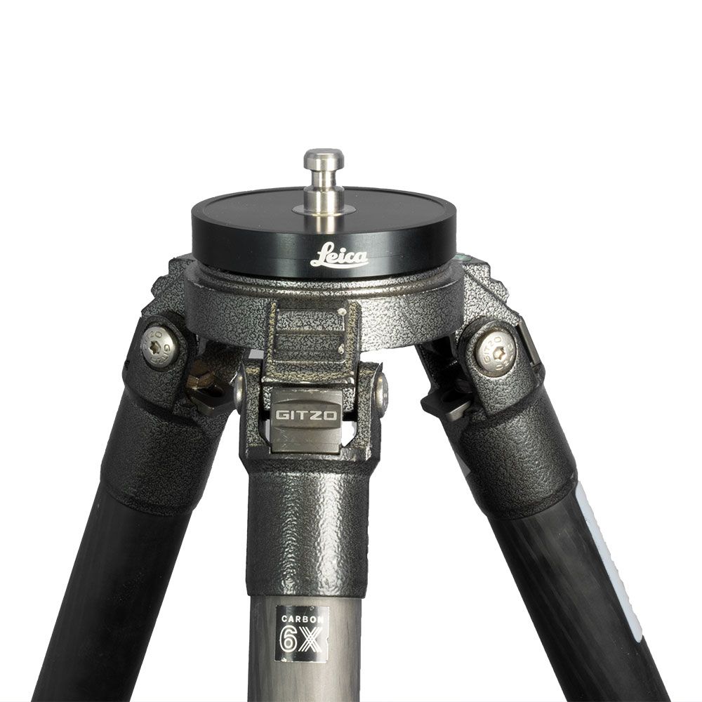A leica tripod is sitting on a white surface