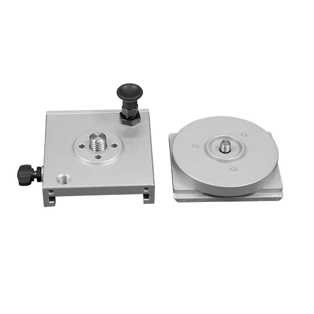A couple of pieces of metal sitting next to each other on a white surface.