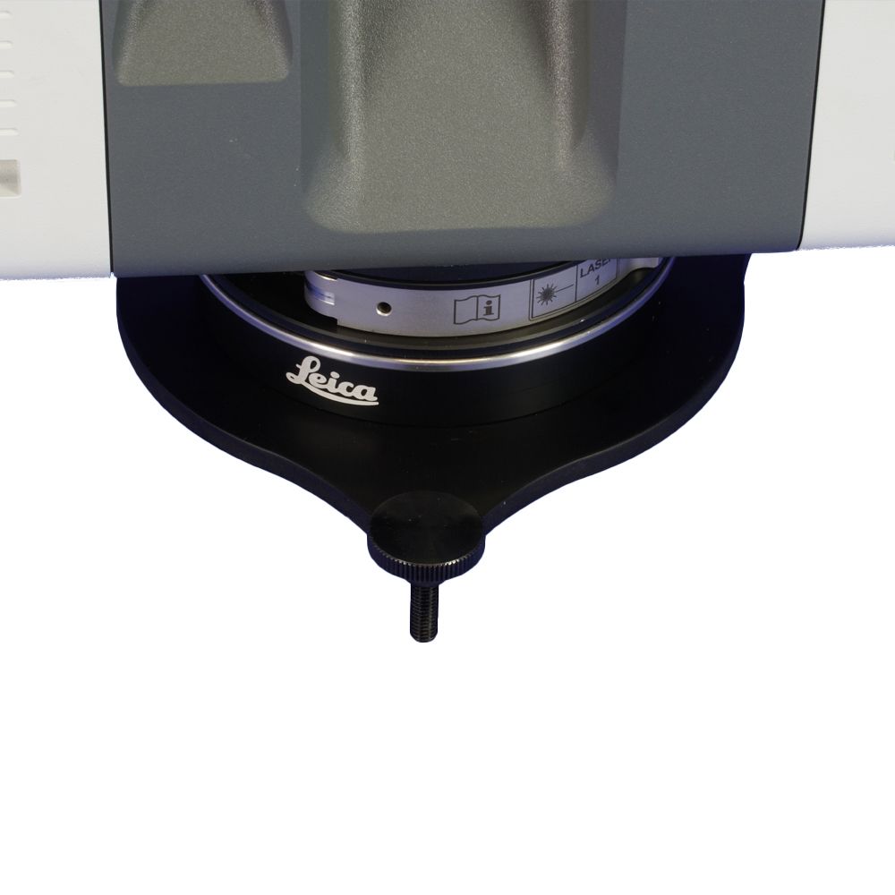 A leica camera is sitting on a white surface
