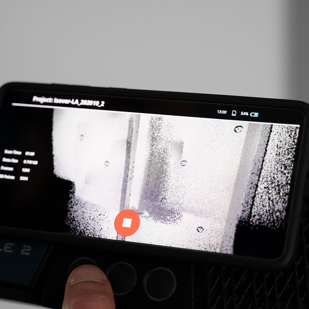 A person is holding a cell phone with a picture of a door on the screen