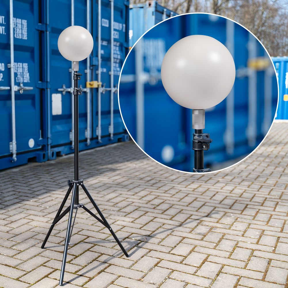 A white ball on a tripod in front of a blue container