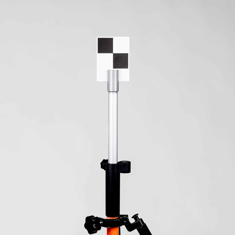 A tripod with a checkered flag on top of it.
