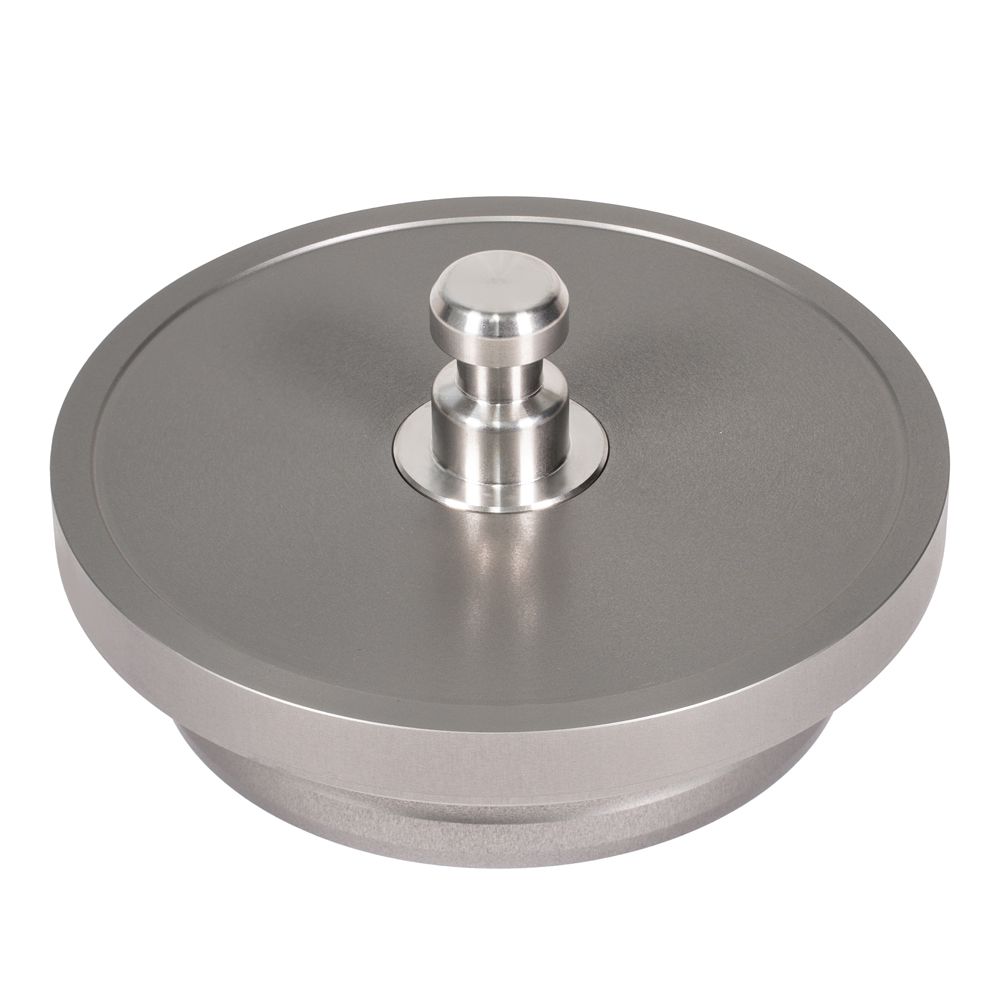 A metal disc with a nut in the middle