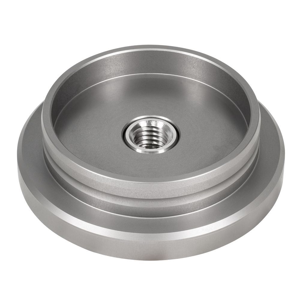 A metal disc with a nut in the middle