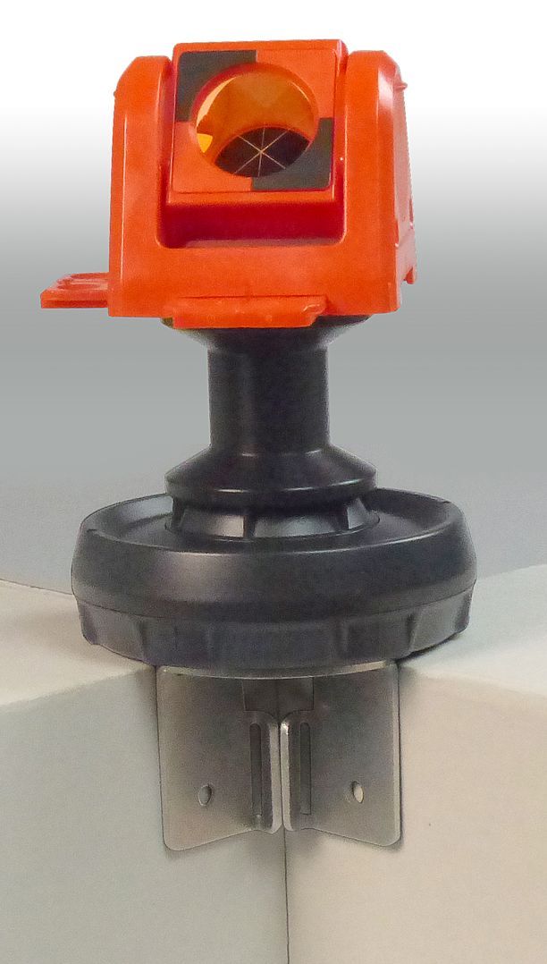 A small orange object is attached to a metal object