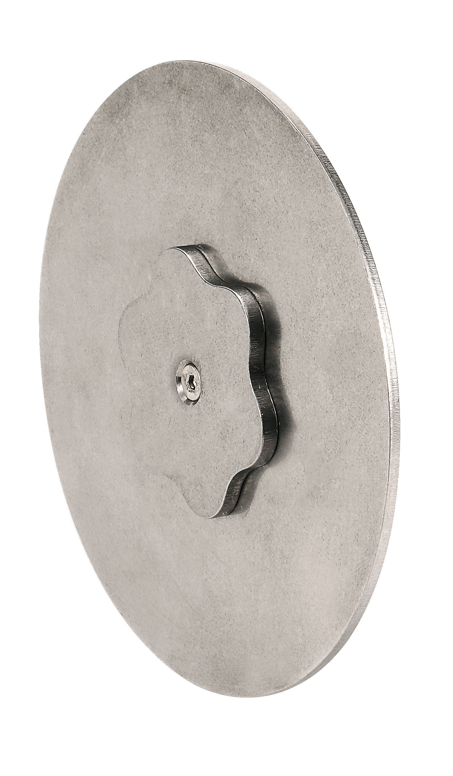 A close up of a metal disc with a hole in the middle on a white background.