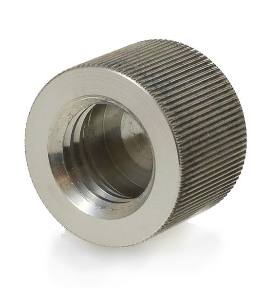 A metal cylinder with a hole in the middle on a white background