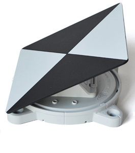 A black and white triangle shaped object is sitting on a white surface.