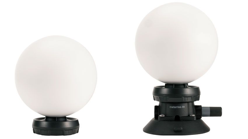 Two white balls on black bases on a white background