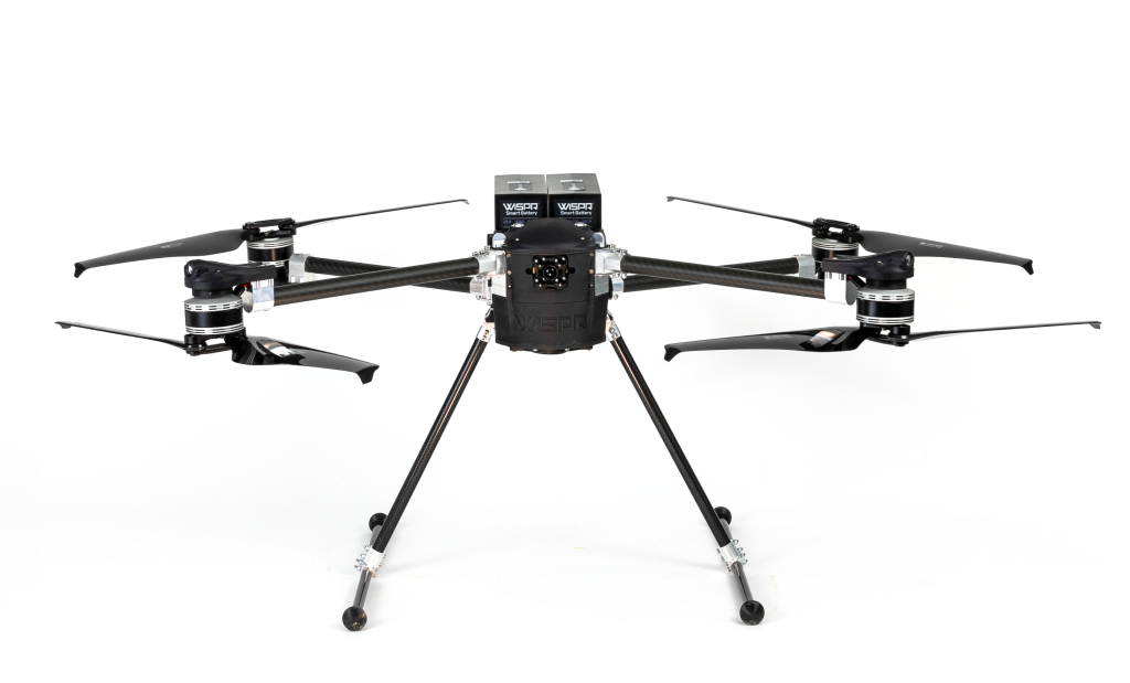 A black drone is sitting on a white surface.