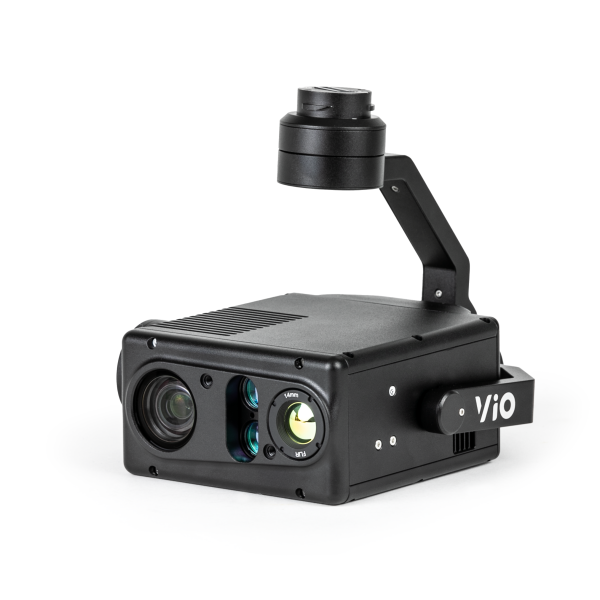 A black camera with two lenses is sitting on a white surface.