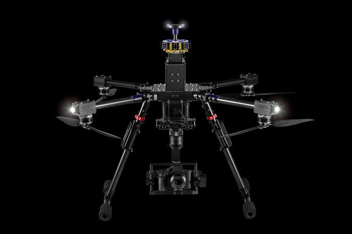 A black and yellow drone is flying in the sky