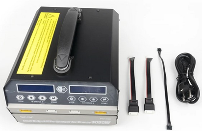 A black device with a yellow warning label on it