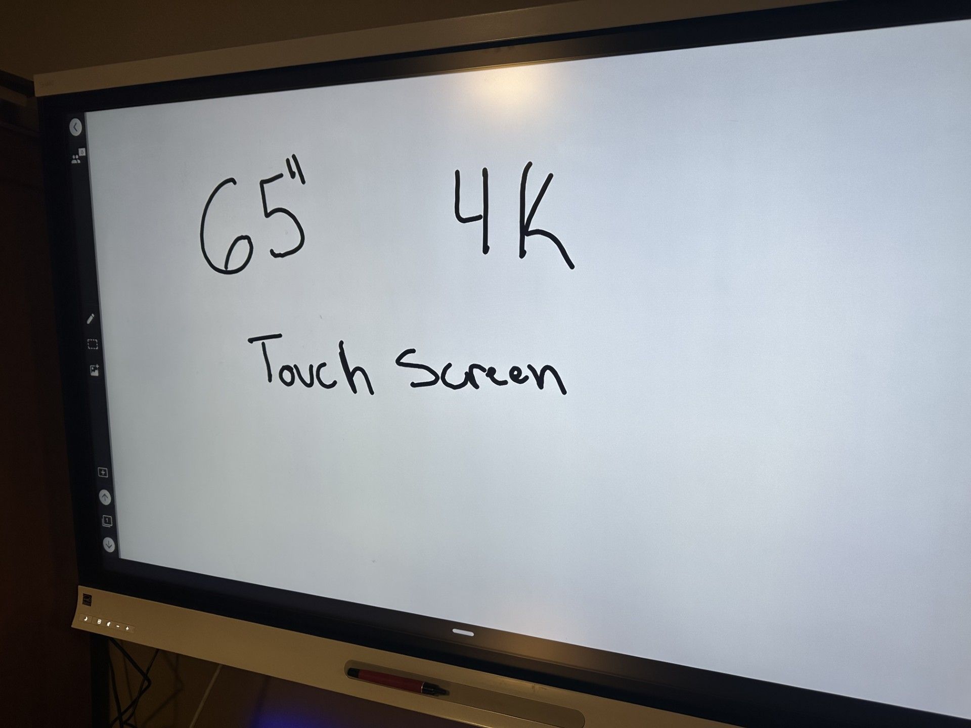 A 65 inch touchscreen is displayed on a white board