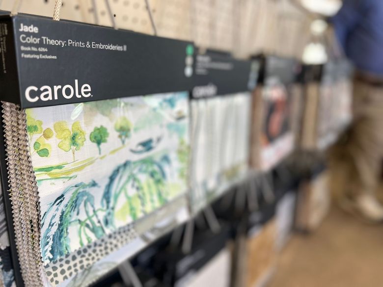 A row of fabric samples on display in a store.