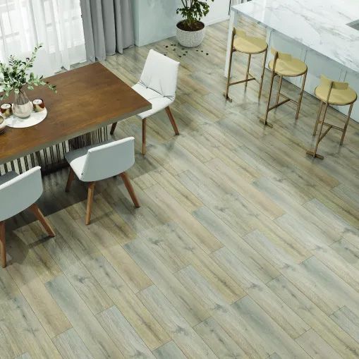 A dining room with a wooden table and chairs and a wooden floor.