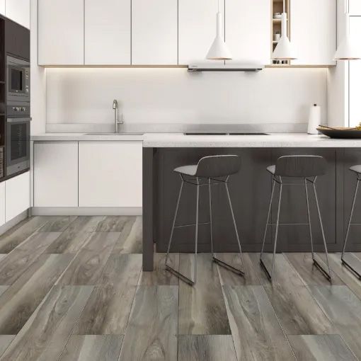 A kitchen with wooden floors and white cabinets and stools